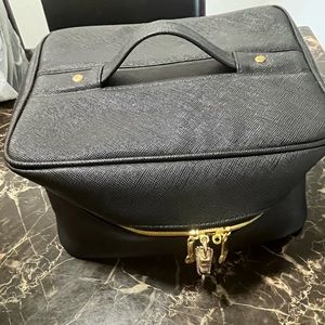 Black makeup or storage case with gold zipper trimmings